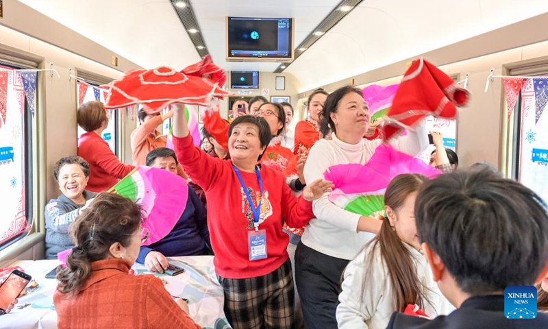 Tourists experience local culture onboard a tourism train in northeast China's Heilongjiang Province, on Dec. 28, 2025. Train Y999/998, an ice-and-snow themed tourism loop train, started a six-day trip on Sunday. (Photo by Yuan Yong/Xinhua)