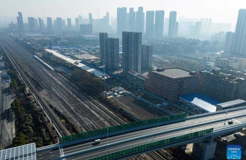 An aerial drone photo shows vehicles running on the northern section of Gutian First Road in Wuhan, central China's Hubei Province, Dec. 28, 2025. The northern section of Gutian First Road in Wuhan was officially completed and opened to traffic on Sunday. The 2.78-kilometer road, crossing the Shanghai-Chongqing-Chengdu high-speed railway, Wuhan-Danjiangkou Railway, and Wuhan Third Ring Road, will benefit residents along the route. (Xinhua/Wu Zhizun)