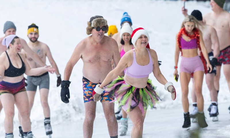People wearing bathing suits participate in the 2025 Toronto Polar Bear Skate event in Toronto, Canada, on Dec. 28, 2025. About 160 skaters participated in this annual event to bid farewell to 2025 on Sunday. (Photo by Zou Zheng/Xinhua)