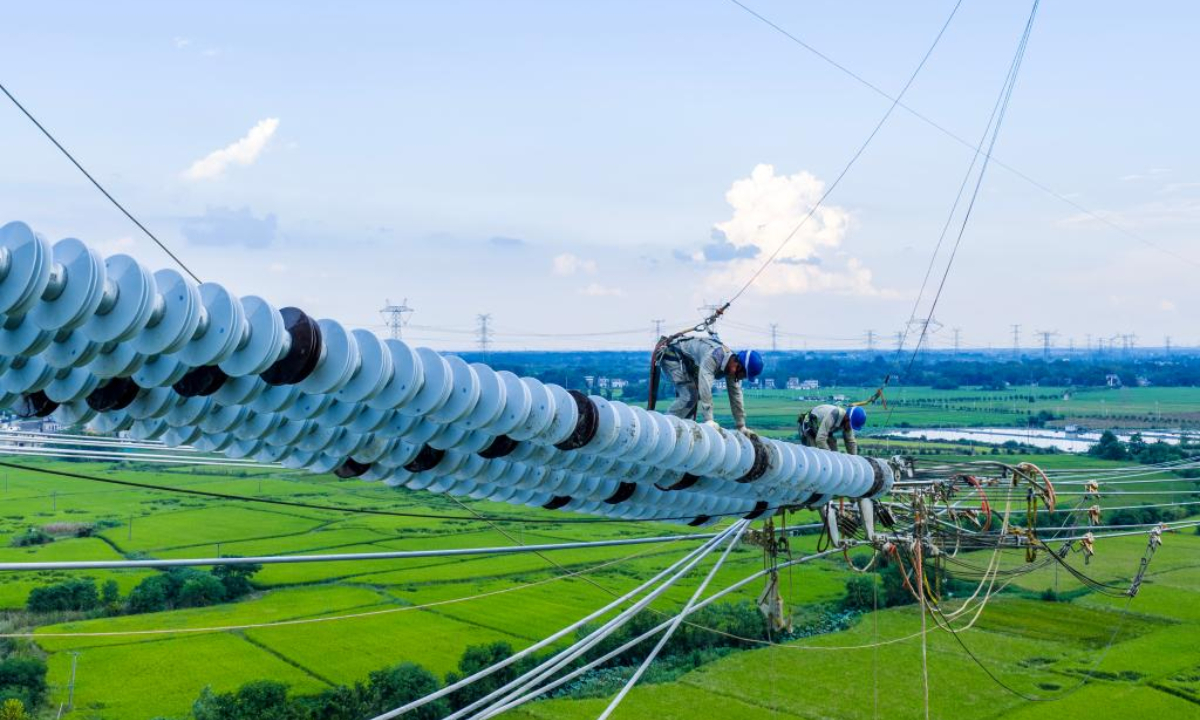 A drone photo taken on Sept. 16, 2025 shows workers carrying out conductor stringing tasks for the Gansu-Zhejiang ±800 kV ultra-high voltage (UHV) direct current transmission project in Nanling County, Wuhu, east China's Anhui Province.  (Photo by Zheng Xianlie/Xinhua)