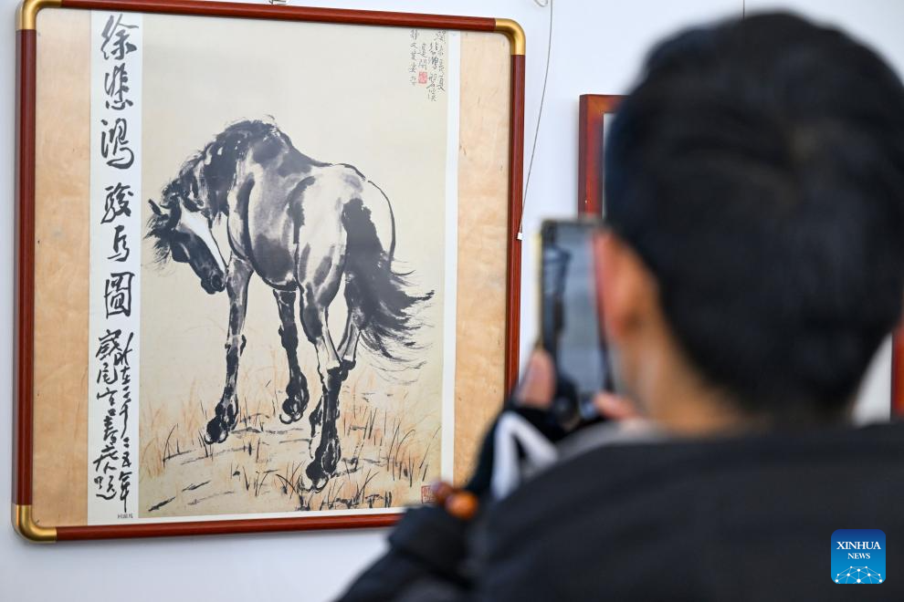 A visitor views a horse painting at an exhibition in north China's Tianjin, Dec. 29, 2025. Various activities are held across China to celebrate the upcoming new year. (Xinhua/Zhao Zishuo)