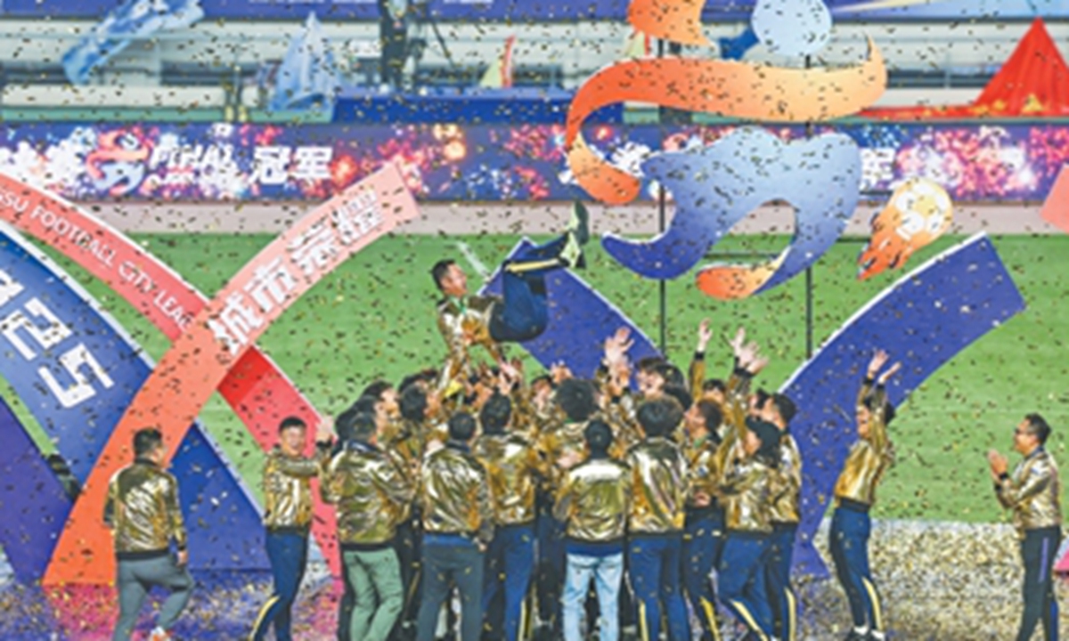 Taizhou players celebrate winning the Jiangsu City Football League. Photo: Xinhua