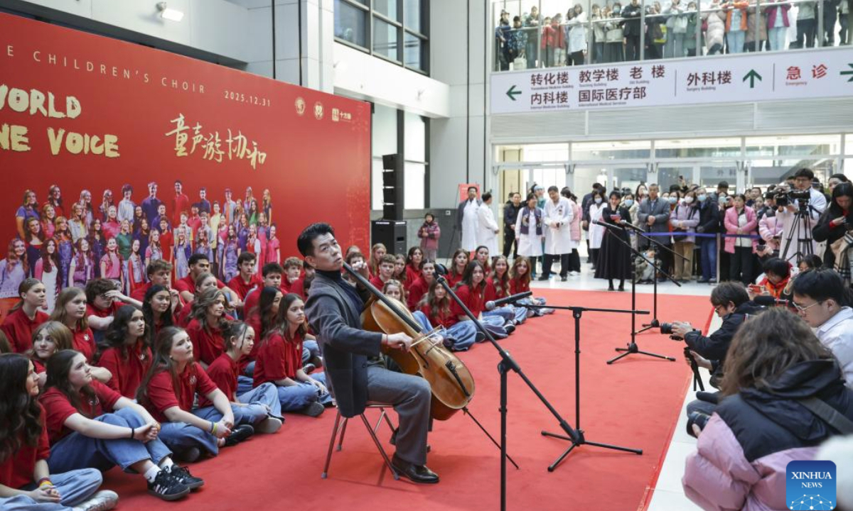 Feng Yao, the principal cellist of the Schleswig-Holstein Symphony Orchestra from Germany, performs at the Peking Union Medical College Hospital (PUMCH) in Beijing, capital of China, Dec. 31, 2025. Fifty-six young performers from One Voice Children's Choir along with invited musicians gave a performance at the hospital on Wednesday. (Xinhua/Zhang Yuwei)
