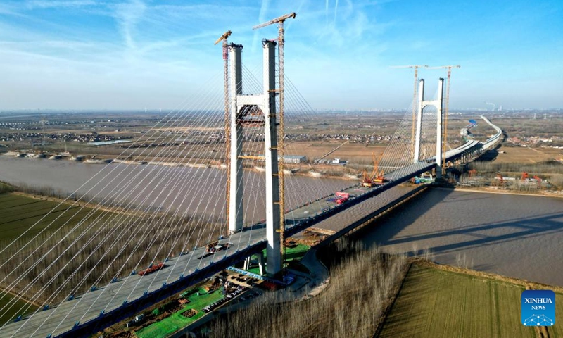 A drone photo taken on Dec. 31, 2025 shows the Dongying Yellow River highway-railway bridge under construction in Dongying, east China's Shandong Province.

The 2,230.4-meter-long Dongying Yellow River highway-railway bridge, a part of the Tianjin-Weifang High-Speed Railway, achieved its closure on Wednesday. The bridge has a double-track high-speed railway at the lower level and a two-way six-lane first-class highway at the upper level.

The Tianjin-Weifang railway will connect Binhai Station in north China's Tianjin and Weifang North Station in east China's Shandong Province, with a total length of approximately 349 kilometers and a designed speed of 350 kilometers per hour. (Xinhua/Zhu Zheng)