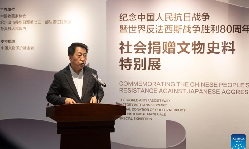 Jin Chengmin, curator of the Exhibition Hall of Evidence of Crimes Committed by Unit 731 of the Japanese Imperial Army, introduces the special exhibition of social donation of cultural relics and historical materials at the exhibition hall in Harbin, capital of northeast China's Heilongjiang Province, on Dec. 31, 2025. The opening ceremony of the special exhibition was held here on Wednesday. (Xinhua/Zhang Tao)