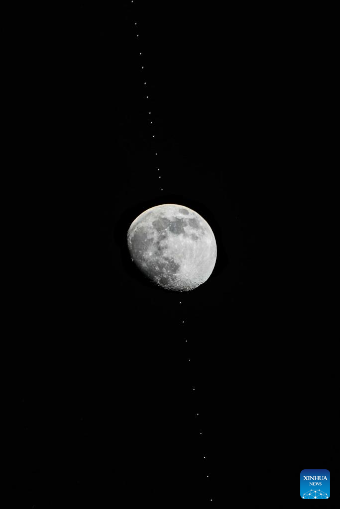 A stacked composite photo taken on Dec. 31, 2025 in Beijing, China shows the Chinese space station passing in front of the Moon. (Xinhua/Xing Guangli)