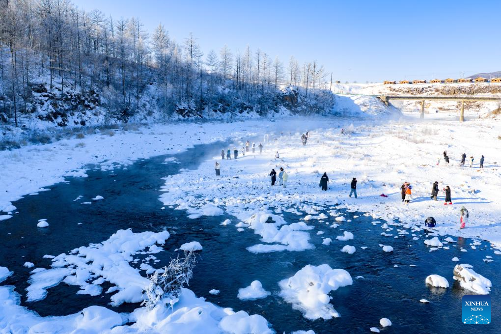 An aerial drone photo shows tourists having fun by the Halha River in the city of Arxan of Hinggan League, north China's Inner Mongolia Autonomous Region, Jan. 1, 2026. Despite Arxan's frigid winter cold, this geothermally-affected section of the Halha River never freezes, which attracts great amount of tourists in winter. (Xinhua/Ma Jinrui)
