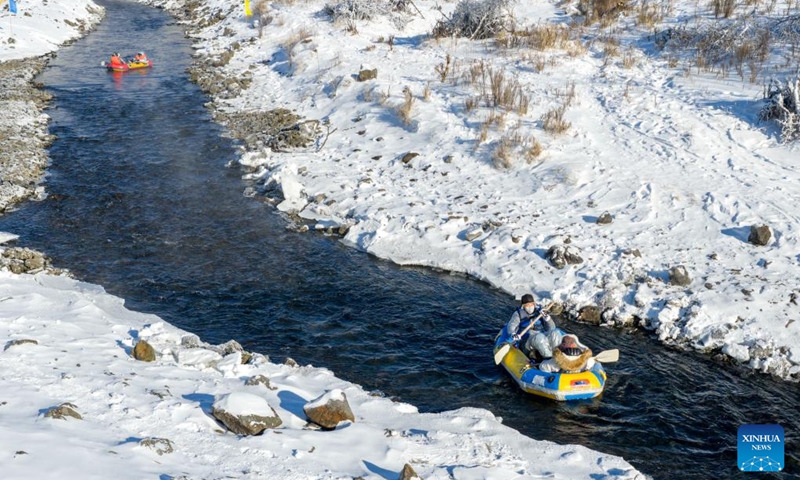 An aerial drone photo shows tourists rafting on the Halha River in the city of Arxan of Hinggan League, north China's Inner Mongolia Autonomous Region, Jan. 1, 2026. Despite Arxan's frigid winter cold, this geothermally-affected section of the Halha River never freezes, which attracts great amount of tourists in winter. (Xinhua/Ma Jinrui)