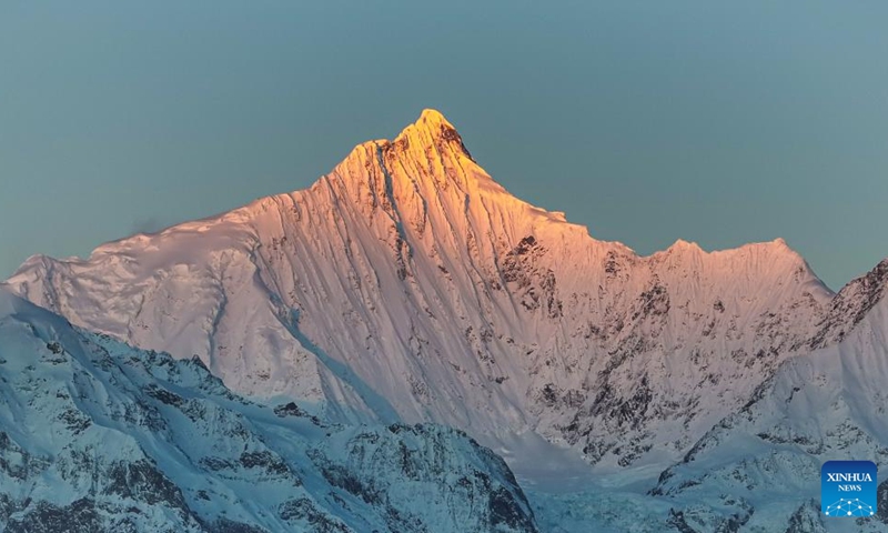 This photo taken on Jan. 1, 2026 shows sunlight shining on the Meili Snow Mountain in Deqen County, southwest China's Yunnan Province. People across China welcome the arrival of 2026 at sunrise. (Photo by Li Chunlei/Xinhua)