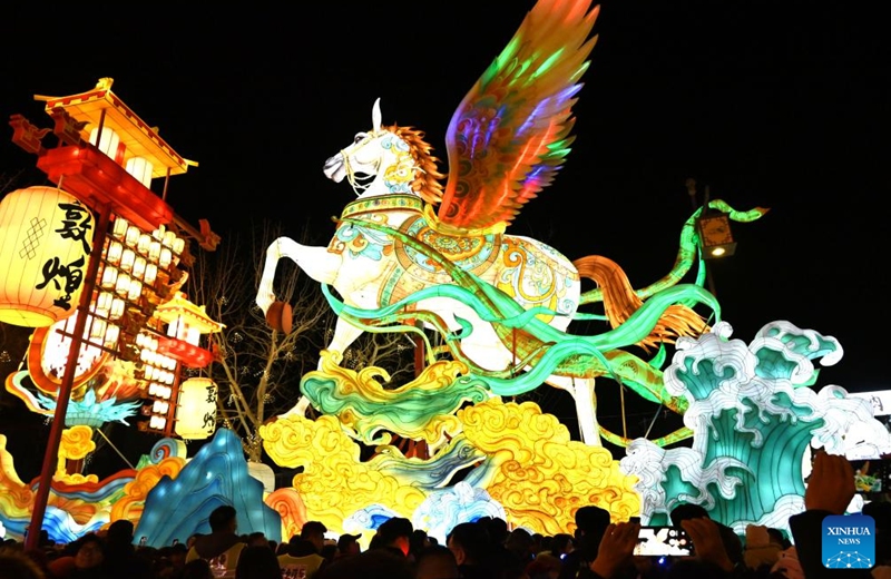 Tourists visit a lantern fair at a night market in Dunhuang, northwest China's Gansu Province, Dec. 31, 2025. The lantern fair kicked off here on Wednesday, attracting many tourists to experience the unique charm of Dunhuang. (Photo by Zhang Xiaoliang/Xinhua)