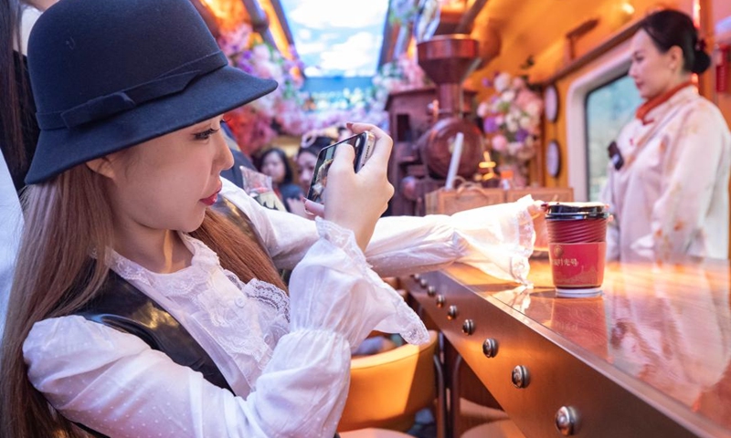 A tourist takes photos on a themed train running from Beijing Railway Station to Tianjin North Railway Station, Jan. 1, 2026. The Tianjin Fantasy Express has begun a scheduled round-trip service between Tianjin North Railway Station and Beijing Railway Station since Thursday. The line features 10 distinctively themed carriages integrating art performances, cultural presentations and intangible cultural heritage experience. Photo: Xinhua
