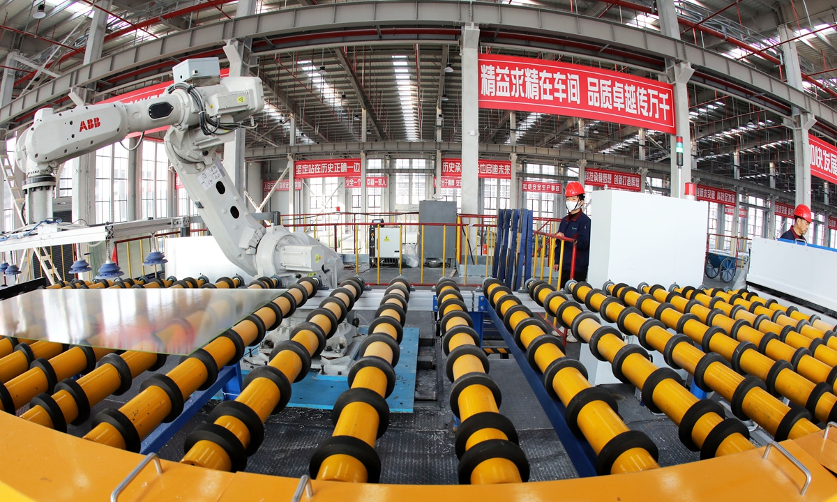 A worker oversees a robotic arm on an intelligent production line of a new materials company in Huaibei, East China's Anhui Province, on January 3, 2026, as the facility works to complete a backlog of orders. In the first 11 months of 2025, the added value of industrial enterprises above designated size in the province rose 9.3 percent year-on-year, ranking third nationwide, per local media reports. Photo: VCG