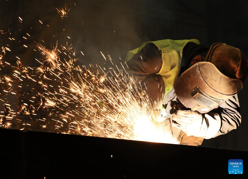 A worker carries out welding tasks at a manufacturing base in Wuhan, central China's Hubei Province, Jan. 5, 2026. At the start of 2026, businesses across China are already busy fulfilling orders and ramping up production, aiming for a sound performance in the first quarter. (Photo by Zhao Jun/Xinhua)