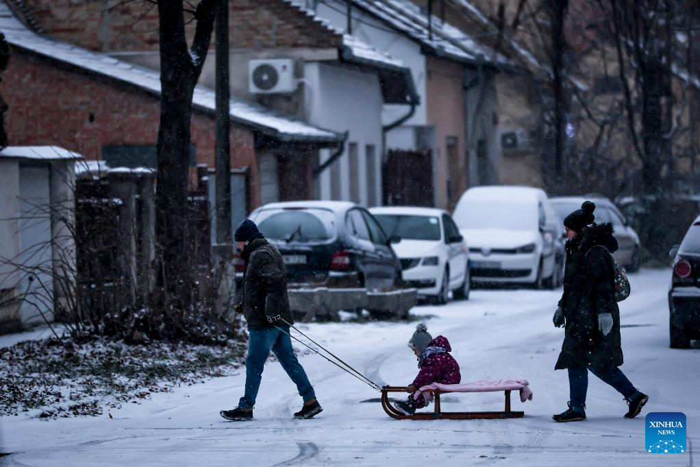 People walk in the snow in Budapest, Hungary on Jan. 5, 2026. (Photo by David Balogh/Xinhua)