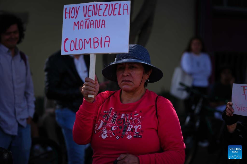 A woman holds a sign during a rally in support of Venezuela outside the U.S. Embassy in Bogota, Colombia, Jan. 3, 2026. The U.S. military launched a series of attacks against Venezuela early Saturday morning, reportedly capturing Venezuelan President Nicolas Maduro and flying him out of the country. (Photo: Xinhua)