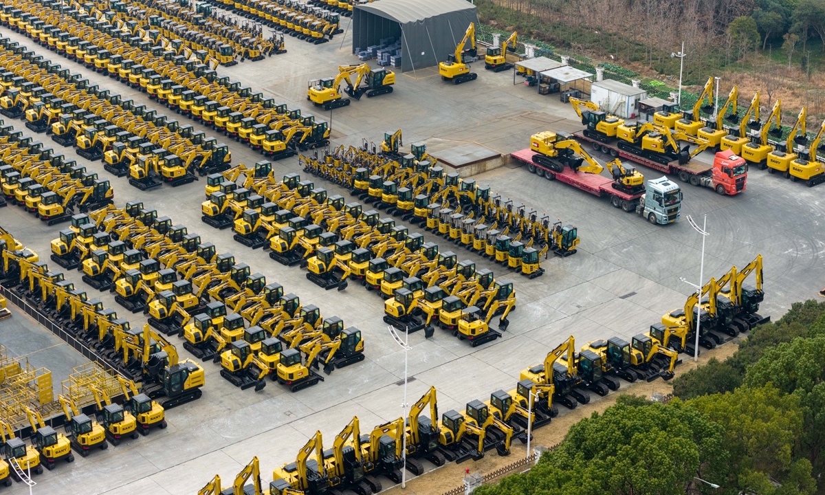 Brightly painted excavators and loaders made by **Sany Group** are lined up and loaded for shipment at one of the company's industrial parks in Kunshan, East China's Jiangsu Province, on January 4, 2026, bound for emerging markets including Southeast Asia, the Middle East, Central Asia and South America. Photo: VCG
