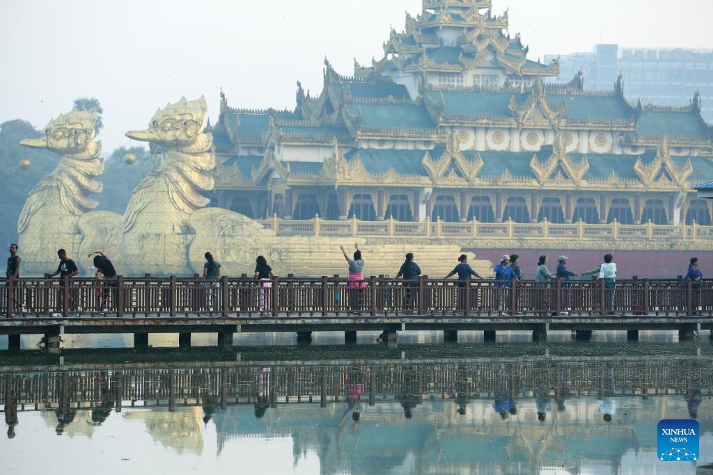 People are pictured at a trestle bridge over Kandawgyi lake in the early morning in Yangon, Myanmar, Jan. 3, 2026. (Photo: Xinhua)