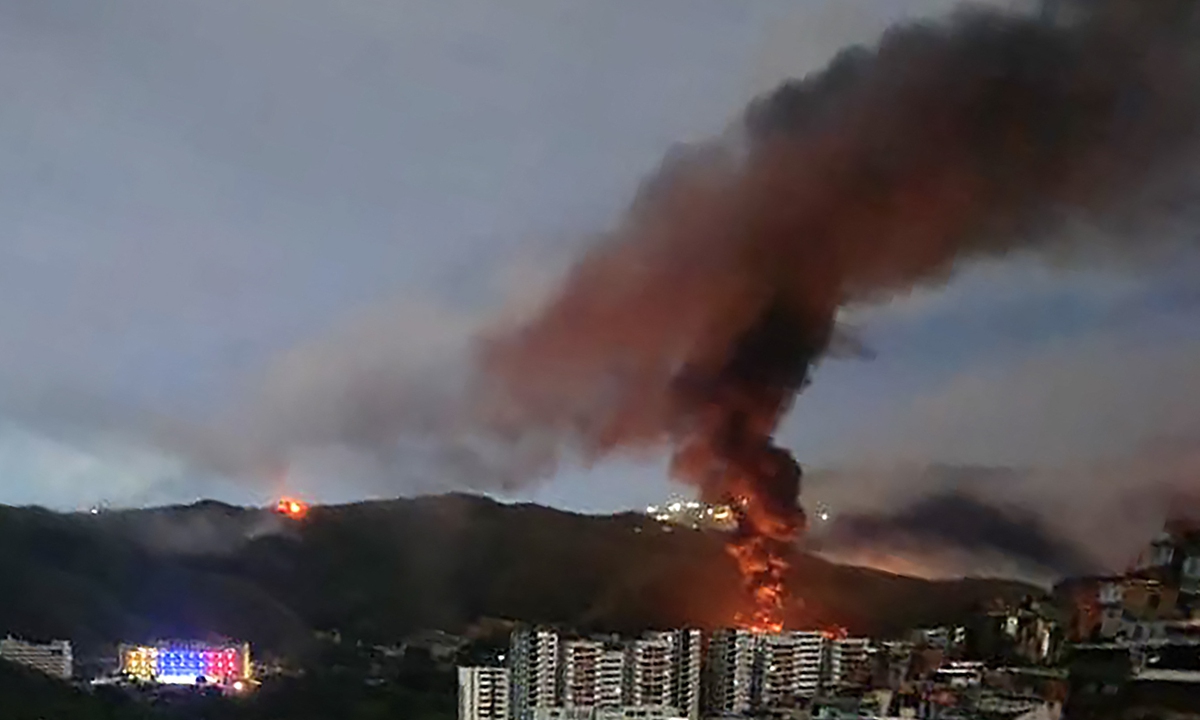 Fire at Fuerte Tiuna, Venezuela's largest military complex, is seen from a distance after a series of explosions in Caracas on January 3, 2026. The US military was behind a series of strikes against the Venezuelan capital Caracas on Saturday, which reportedly led to the capture of Venezuelan President Nicolas Maduro and his wife, US media reported. Photo: AFP