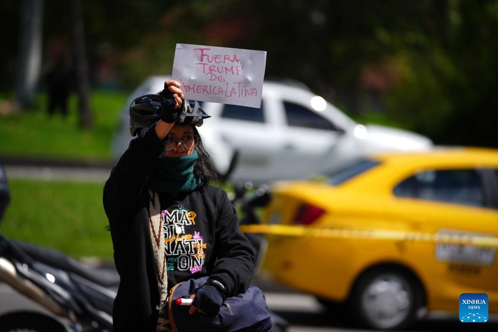 A woman holds a sign during a rally in support of Venezuela outside the U.S. Embassy in Bogota, Colombia, Jan. 3, 2026. The U.S. military launched a series of attacks against Venezuela early Saturday morning, reportedly capturing Venezuelan President Nicolas Maduro and flying him out of the country. (Photo: Xinhua)