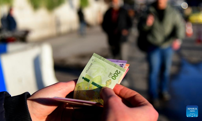 A Syrian citizen exchanges newly issued Syrian pound banknotes at a designated exchange point in Damascus, Syria, Jan. 4, 2026. Syria has begun circulating its new currency following a nationwide exchange process launched earlier this month. (Photo: Xinhua)
