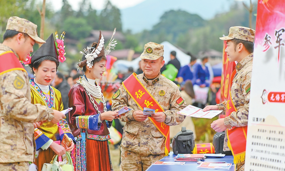 Personnel from the People's Armed Forces office conduct military draft activities during the traditional Lusheng festival in Liangzhai Township, the Rongshui Miao Autonomous County, South China's Guangxi Zhuang Autonomous Region, on January 5, 2026. Personnel explained the state's preferential recruitment policies to local youth of eligible age and ethnic minority residents, encouraging young people, including high school graduates and college graduates, to enlist in the military. Photo: VCG