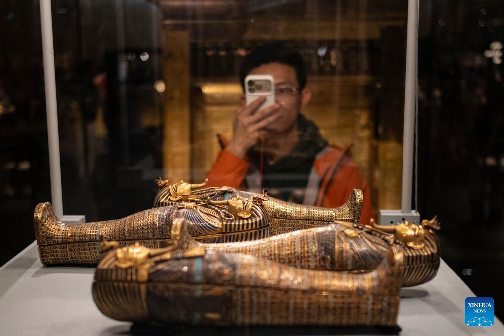 This photo taken on Dec. 20, 2025 shows a visitor taking photos of exhibits at the Grand Egyptian Museum in Giza, Egypt. (Photo: Xinhua)