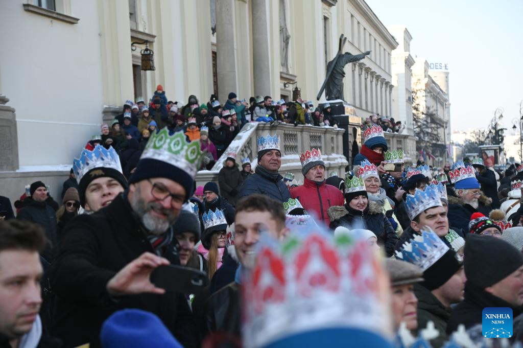 People wearing festive paper crowns attend the Epiphany procession in Warsaw, Poland, Jan. 6, 2026. (Photo by Aleksy Witwicki/Xinhua)