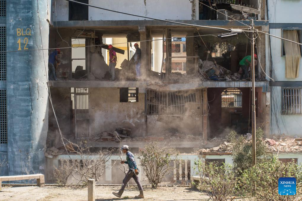 Workers operate in a building damaged by a U.S. airstrike in the Soublette neighborhood of Catia La Mar, Venezuela, Jan. 5, 2026. (Str/Xinhua)