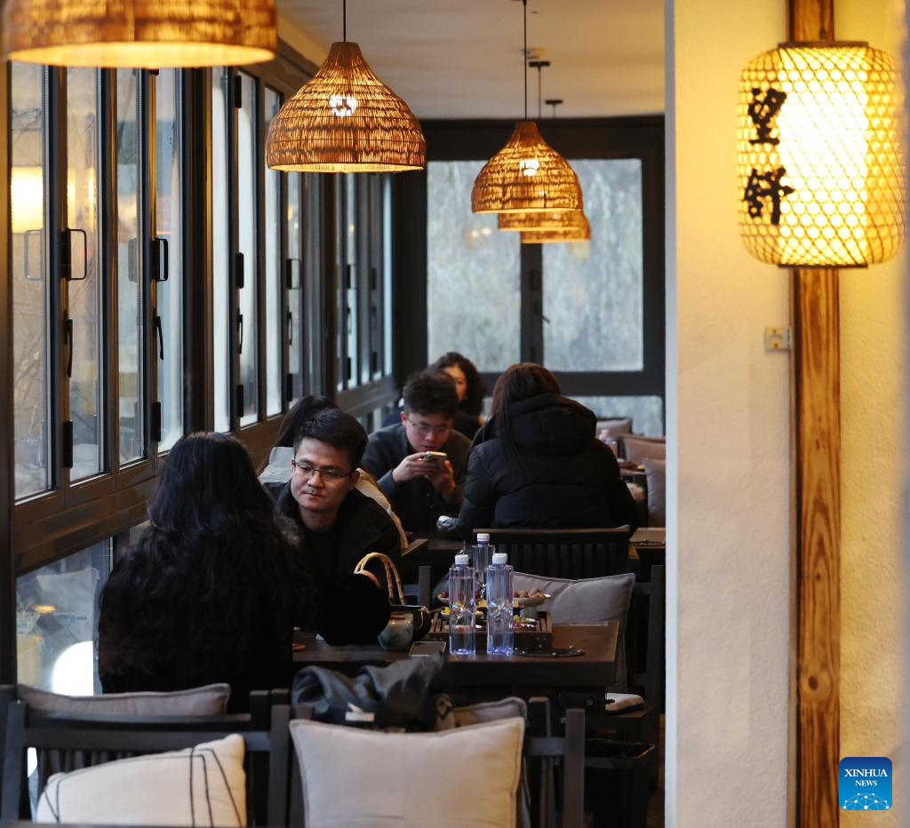 Customers drink tea at a tea house in Qilihe District of Lanzhou, northwest China's Gansu Province, on Jan. 6, 2026. At the beginning of the new year, Lanzhou has been actively creating a festive atmosphere and promoting the upgrading of mature business districts and characteristic streets in the urban area. A series of new products and services has been launched to boost the consumption. (Xinhua/Chen Bin)