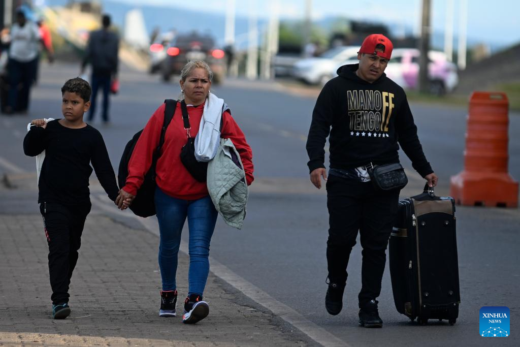 Poeple arrive in Pacaraima, Roraima, Brazil after crossing the border between Brazil and Venezuela, Jan. 7, 2026. (Photo by Lucio Tavora/Xinhua)