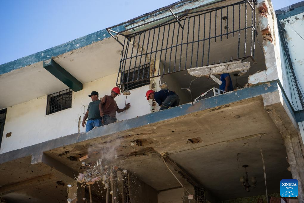 Workers operate in a building damaged by a U.S. airstrike in the Soublette neighborhood of Catia La Mar, Venezuela, Jan. 5, 2026. (Str/Xinhua)