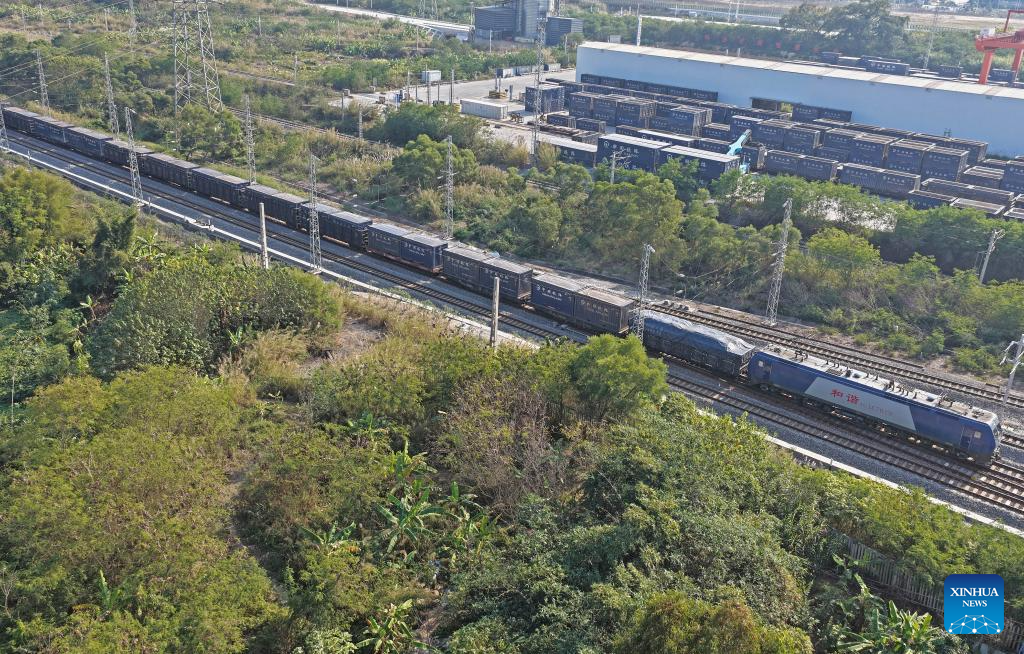 A drone photo taken on Jan. 8, 2026 shows a train leaving the Nanning International Railway Port in Nanning, south China's Guangxi Zhuang Autonomous Region. China's New International Land-Sea Trade Corridor rail service handled a record 1.425 million twenty-foot equivalent units (TEUs) of cargo in 2025, marking a 47.6 percent increase and surpassing the one-million-TEU milestone for the first time, China Railway Nanning Group said on Tuesday. (Xinhua/Zhou Hua)