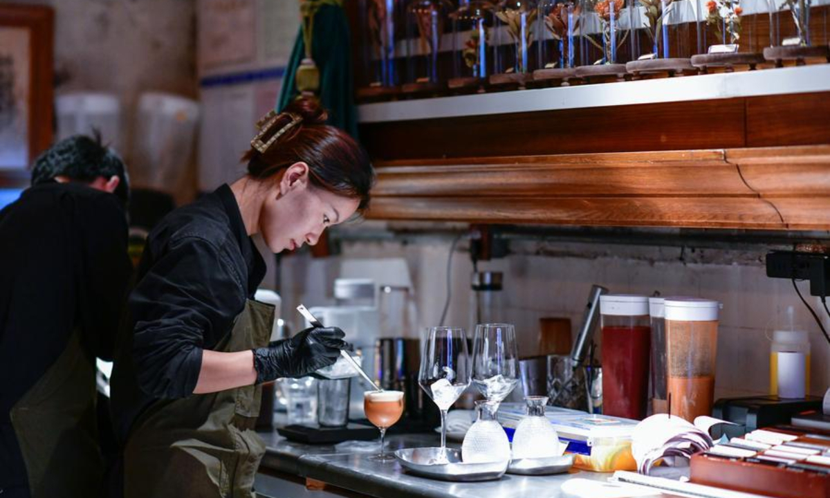 A shop assistant makes coffee at a coffee shop in Guiyang, southwest China's Guizhou Province, June 23, 2025. (Xinhua/Yang Wenbin)