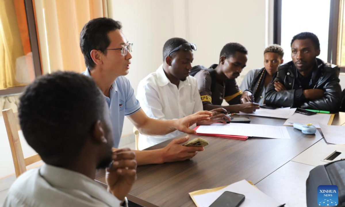 Qian Xiangming (2nd L), dean of Musanze International College at Jinhua University of Vocational Technology (JUVT), provides employment guidance to Rwandan graduates at a Chinese-funded enterprise in Eastern Province, Rwanda, Jan. 5, 2026. (Xinhua/Ju Yinhe)