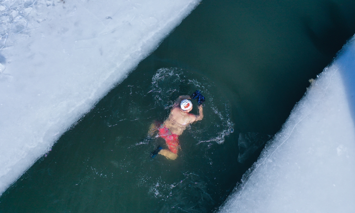 A man swims in the cold water of the Hunhe River in Shenyang, Northeast China's Liaoning Province on January 7, 2026. The lowest temperatures in Shenyang have dropped to -20 C recently. Winter sports are deeply rooted in the city's culture, and the people take great pleasure in them. Photo: VCG