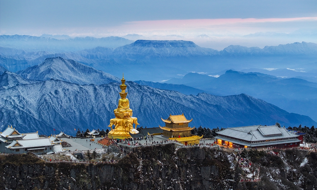 Tourists visit the Golden Summit of Mount Emei, one of the four sacred Buddhist mountains of China, in Southwest China's Sichuan Province on January 8, 2025, after the first snowfall of the year in the region. The Golden Summit is a renowned Buddhist sanctuary famous for its towering statues and breathtaking alpine scenery. Photo: VCG