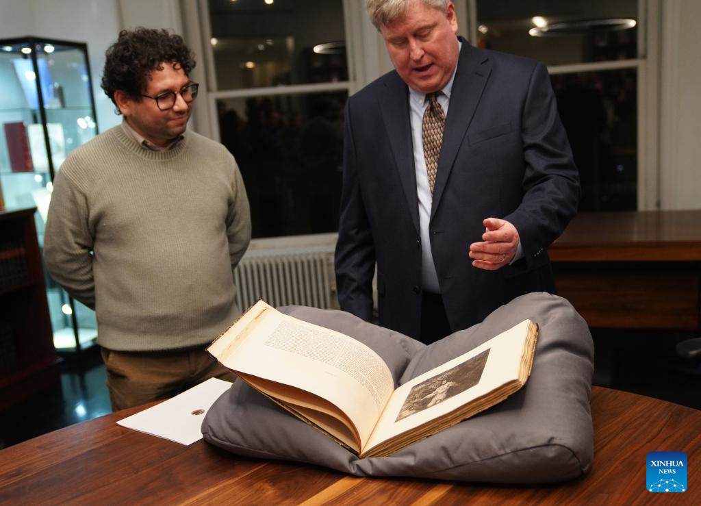 Patrick Lenaghan (R), curator of prints and photographs at the Hispanic Society Museum & Library, speaks during a public display of the original first-edition prints of The Disasters of War by Spanish artist Francisco Goya in New York, the United States, on Jan. 13, 2026. (Xinhua/Zhang Fengguo)