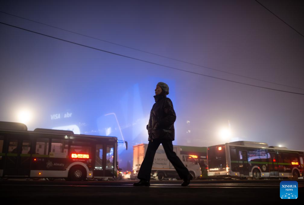 A pedestrian crosses the street in heavy fog in Almaty, Kazakhstan, on Jan. 13, 2026. (Xinhua/Li Renzi)