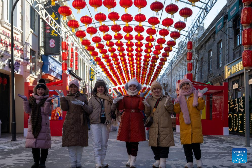 Tourists pose for photos at the Chinese Baroque Historic and Cultural Block in Harbin, northeast China's Heilongjiang Province, Jan. 14, 2026. Harbin is a major winter tourism destination in northeast China. The city's Chinese Baroque Historic and Cultural Block is attracting an increasing number of visitors. The century-old architectural complex, a fusion of Chinese and Western styles, displays a unique charm as the ice and snow season peaks. (Xinhua/Zhang Tao)