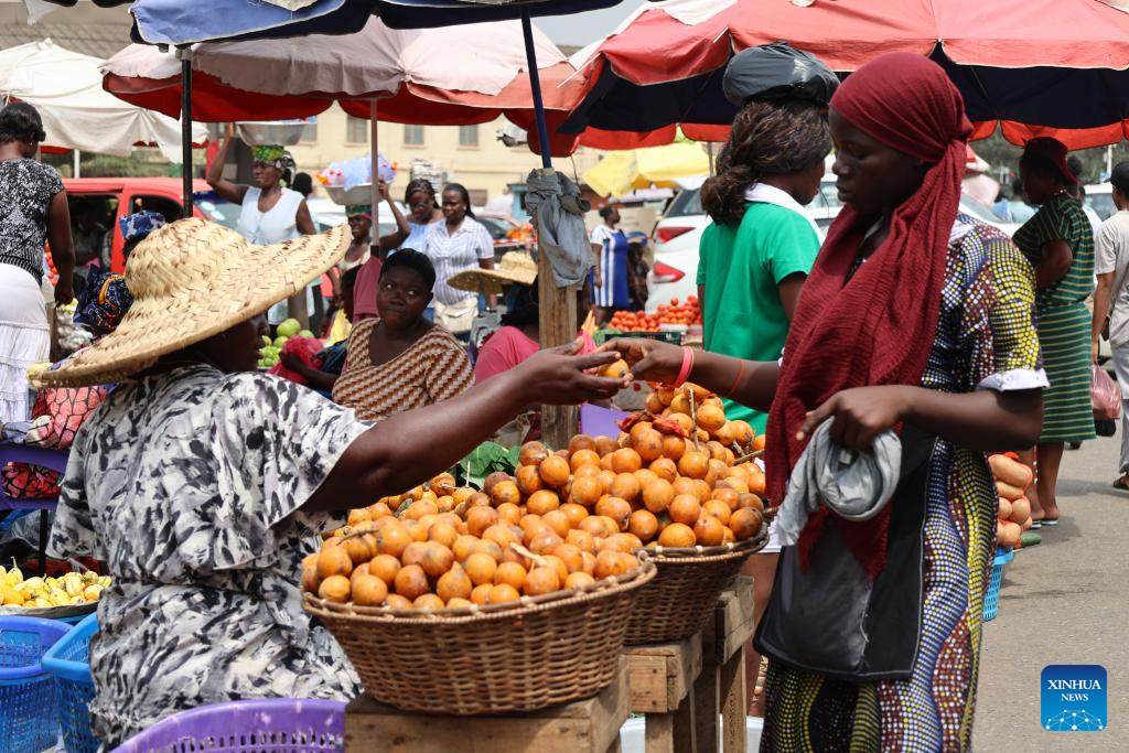 A woman buys fruit at a street market in Accra, Ghana, on Jan. 14, 2026. (Photo by Seth/Xinhua)