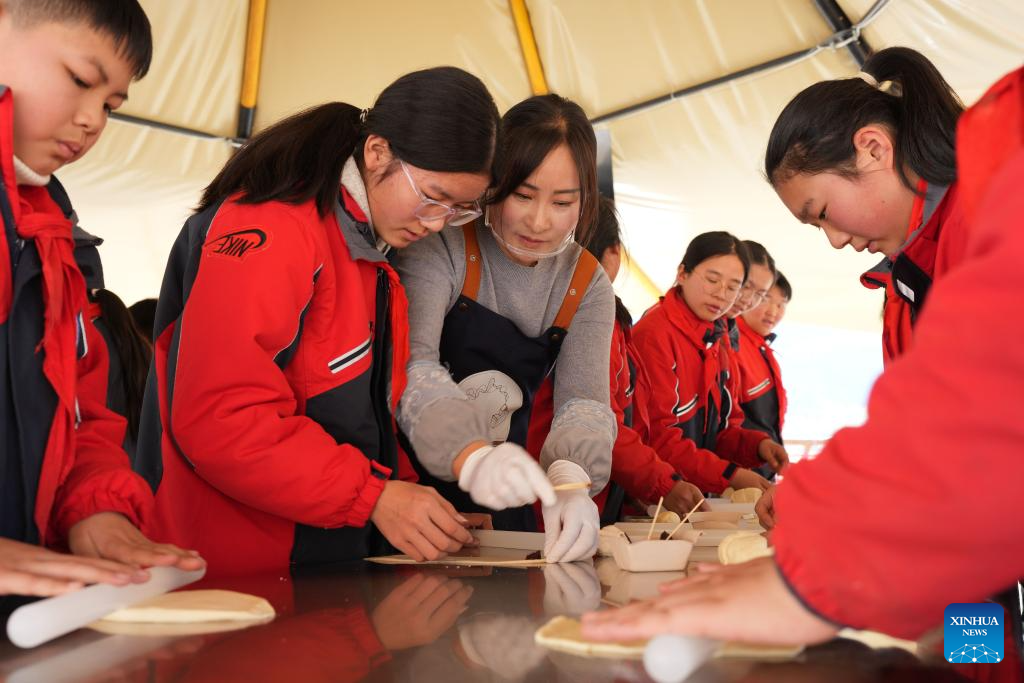 Students enjoy a bread-making event during a study tour in Lulikeng Village of Changshan County, east China's Zhejiang Province, Jan. 14, 2026. Lulikeng Village has renovated its abandoned lime kilns into rural tourism facilities in recent years, turning the village into a destination for tourists from surrounding areas. Since 2024, various business sectors in the village have enabled over 150 villagers to find jobs right at their doorstep, and increased the village's income by more than 6 million yuan (about 0.86 million U.S. dollars). (Xinhua/Weng Xinyang)