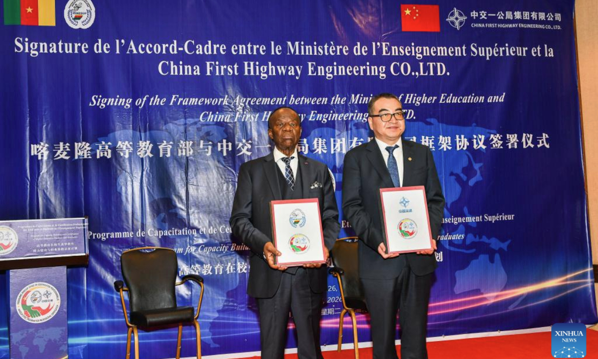 Cameroonian Minister of Higher Education Jacques Fame Ndongo (L) and Zhao Zongzhi, chief engineer of China First Highway Engineering Co., Ltd. (CFHEC) display signed documents after the signing ceremony of a framework agreement for the MINESUP-CFHEC Professional Certification Program in Yaounde, capital of Cameroon, Jan. 13, 2026. (Photo by Kepseu/Xinhua)