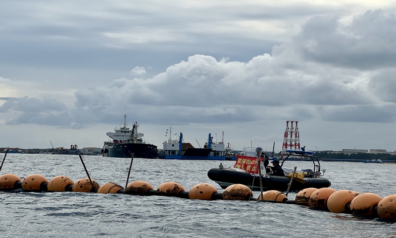 The Japanese government cordons off waters near the Henoko base with orange buoys. A patrol vessel closes in and issues warnings to the boat of the Global Times on approach to the construction site, on December 24, 2025. Photo: Xing Xiaojing/GT