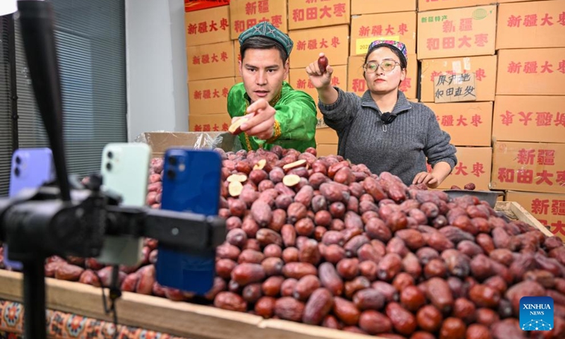Staff members promote products via live-streaming at a network technology company in Moyu County, Hotan Prefecture, northwest China's Xinjiang Uygur Autonomous Region, Jan. 9, 2026. Premium Xinjiang goods like walnuts and red jujubes, which are popular choices for customers nationwide for the Chinese New Year, have entered their peak sales season as the Spring Festival approaches. E-commerce companies in Hotan are leveraging live-streaming sales and online shopping festivals to promote high-quality agricultural products of Xinjiang, boosting farmers' incomes and rural revitalization. (Photo: Xinhua)