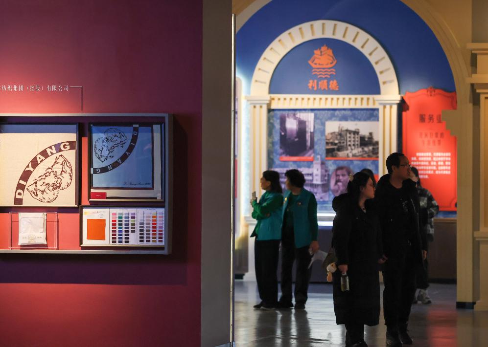 People visit an exhibition featuring modern Tianjin's industry and commerce at the Tianjin Museum in Tianjin, north China, Jan. 13, 2026. Featuring over 320 historical photographs and more than 120 pieces (sets) of physical exhibits, the exhibition will last for three months and be open to the public free of charge. (Xinhua/Sun Fanyue)