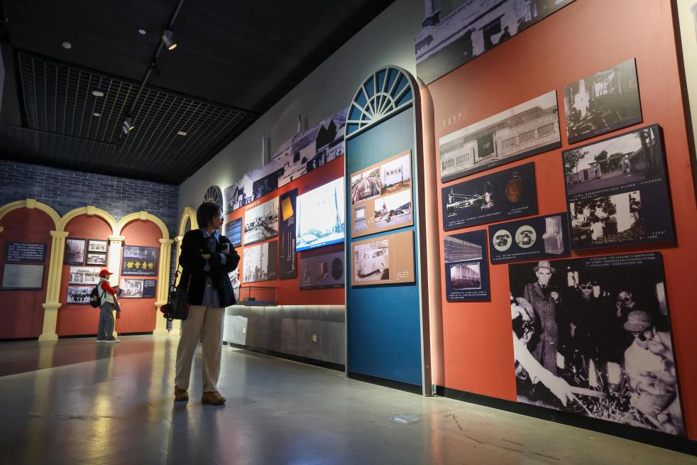 People visit an exhibition featuring modern Tianjin's industry and commerce at the Tianjin Museum in Tianjin, north China, Jan. 13, 2026. Featuring over 320 historical photographs and more than 120 pieces (sets) of physical exhibits, the exhibition will last for three months and be open to the public free of charge. (Xinhua/Sun Fanyue)