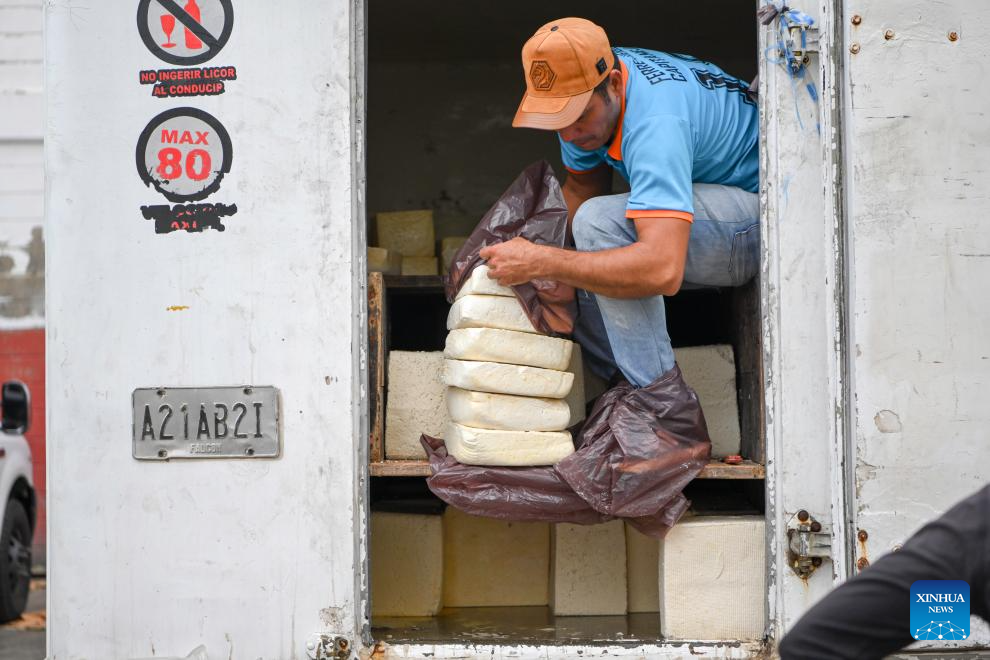 A man takes out cheese from a truck at a cheese market in Caracas, Venezuela, Jan. 13, 2026. (Xinhua/Ding Hongfa)