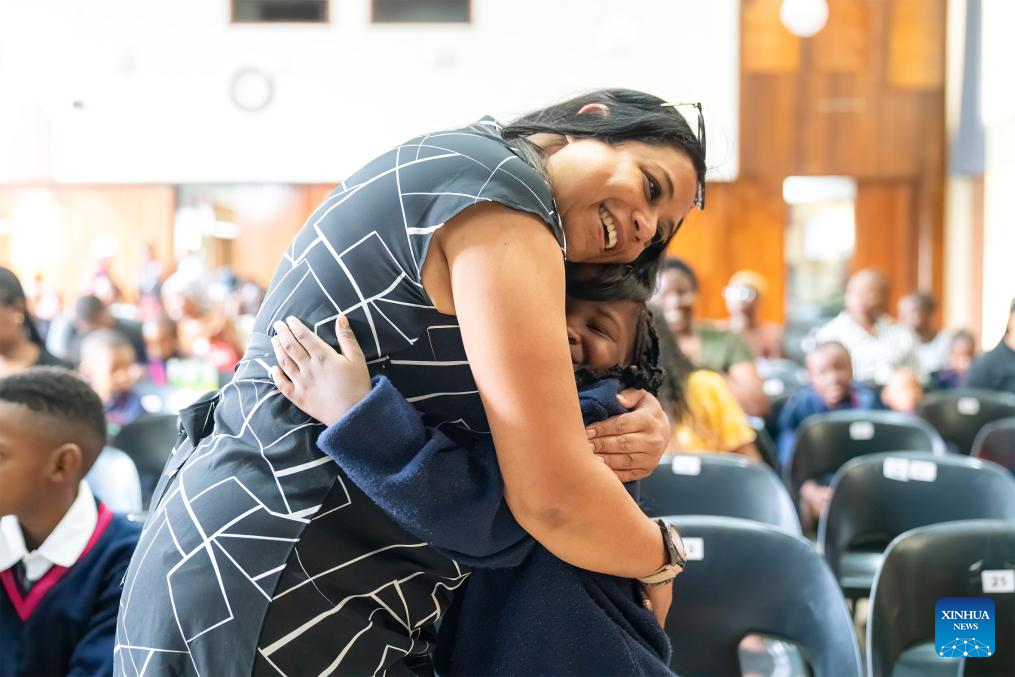 A teacher hugs a student on the first day of a new semester at a school in Johannesburg, South Africa, Jan. 14, 2026. (Photo by Shiraaz Mohamed/Xinhua)