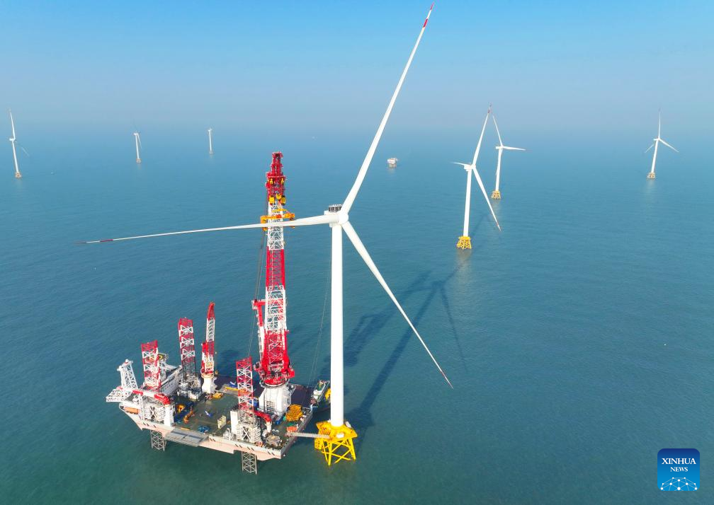 This drone photo taken on Jan. 13, 2026 shows the construction site of a 20-megawatt offshore wind turbine unit in the coastal waters of southeast China's Fujian Province. The wind turbine unit was successfully hoisted and installed here on Tuesday. (Xinhua/Lin Shanchuan)