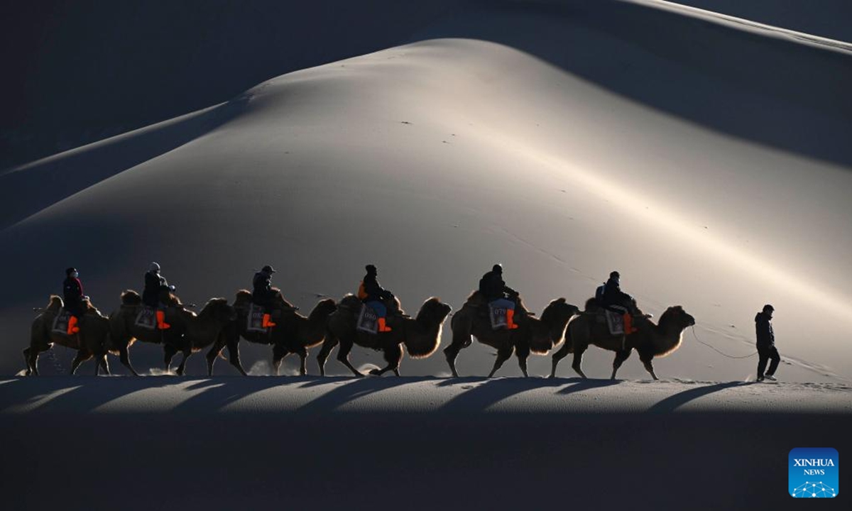 Tourists visit the Mingsha Mountain and Crescent Spring Scenic Area in Dunhuang City, northwest China's Gansu Province, Jan. 10, 2026. (Photo by Zhang Xiaoliang/Xinhua)